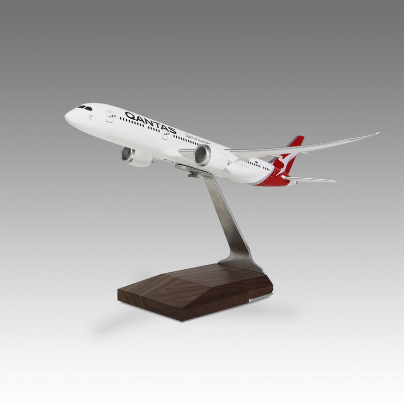 A Pacmin Studios desktop model of Qantas Airways Boeing 787-9 aircraft, mounted on a wooden base.