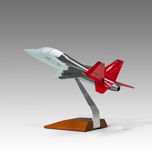 U.S. Air Force T-7A Red Hawk scale aircraft model on wood base by Pacmin Studios showcasing the back left
